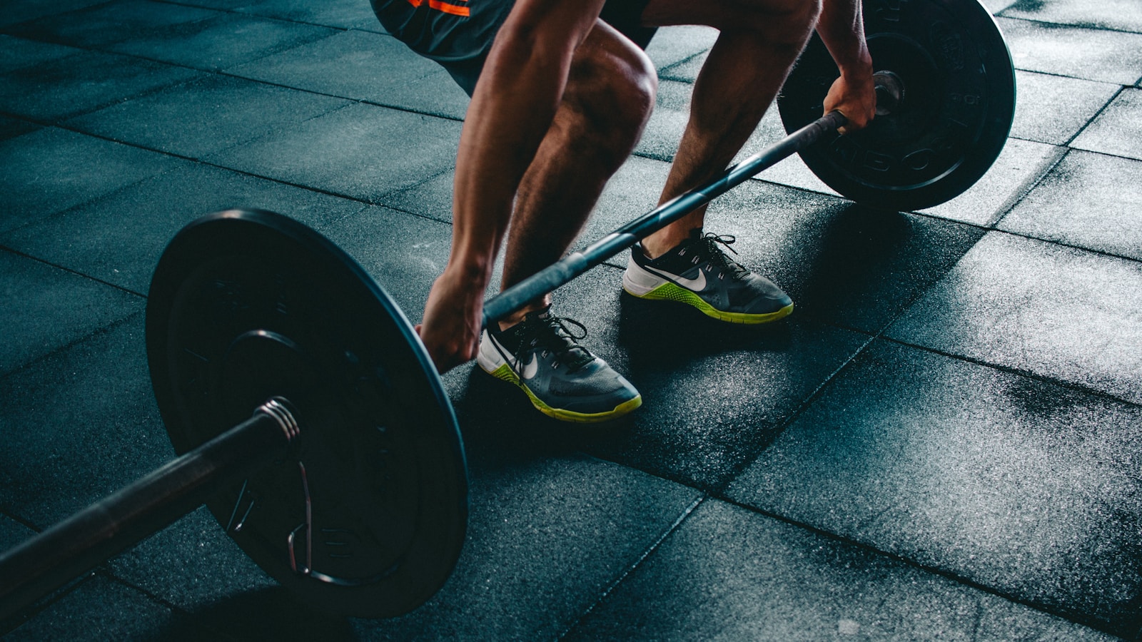 Person performing a goblet squat with a kettlebell in a home gym