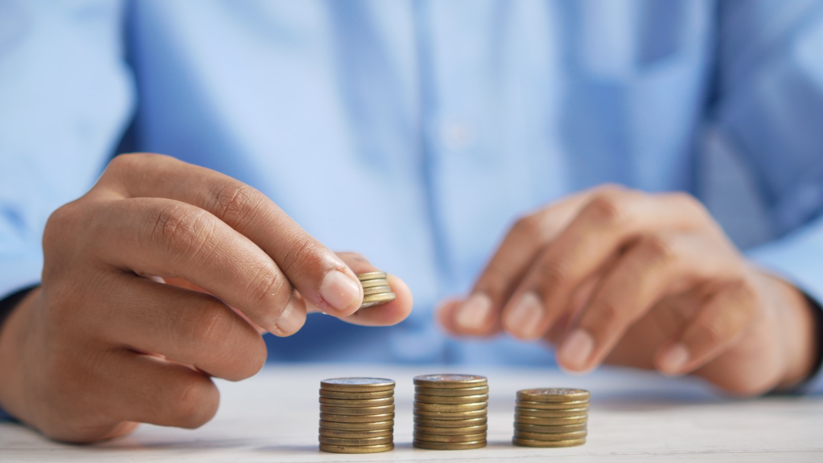 Person dividing cash into envelopes for monthly budgeting
