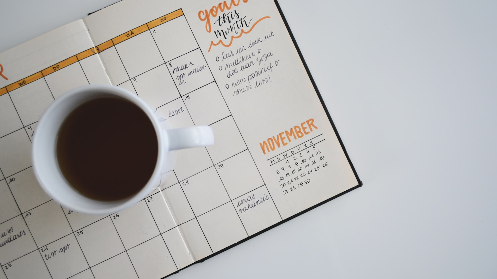 Color-coded weekly calendar on a screen with planning notes beside it