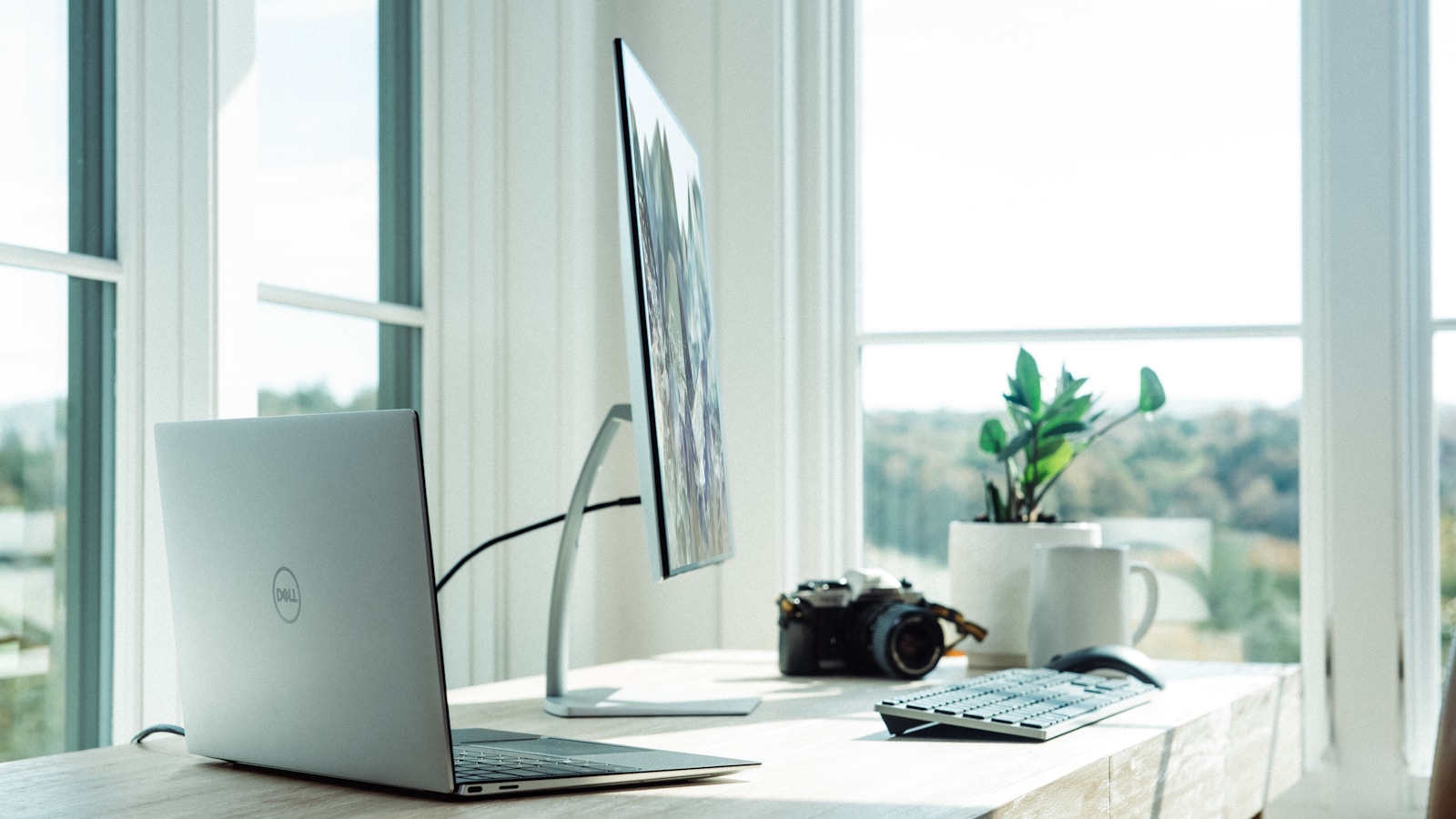 Tidy home office with monitor, ergonomic chair and natural light